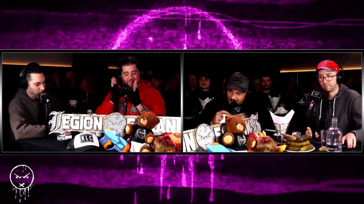 Still image of the Legion of Skanks podcast, featuring Dave Smith, Jay Oakerson, Luis Gomez, and Joe List sitting at a table.